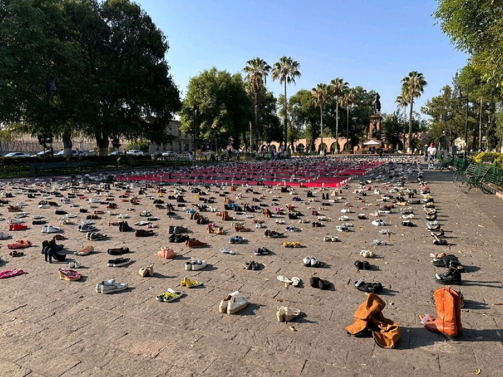 candidata coloca zapatos de niños a modo de recuerdo simbólico